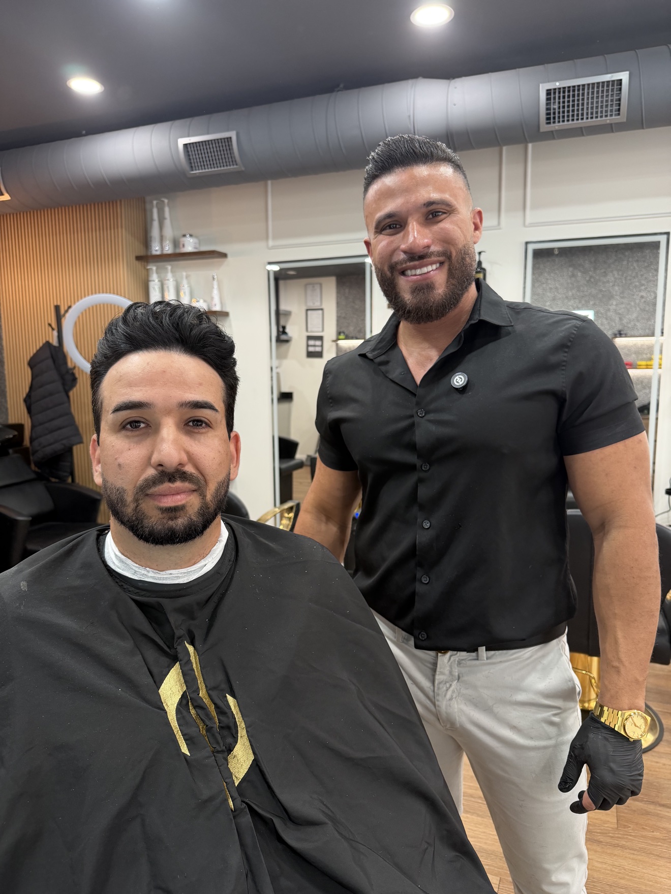 Barber smiling with a client after a service