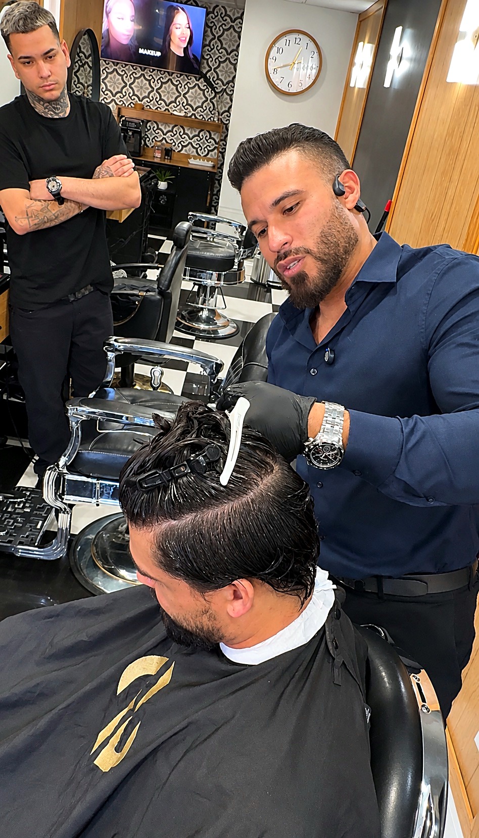 Lucas cutting a client's hair in the shop