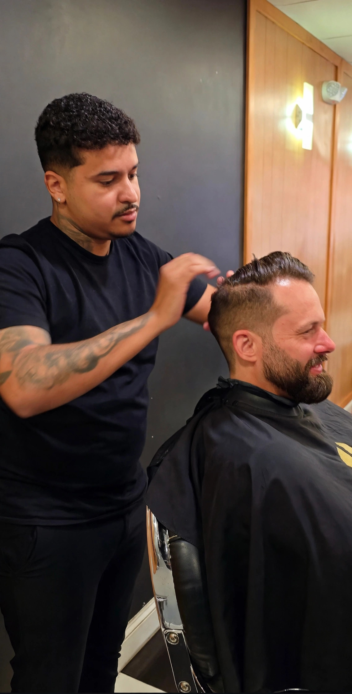 Barber styling a client's hair